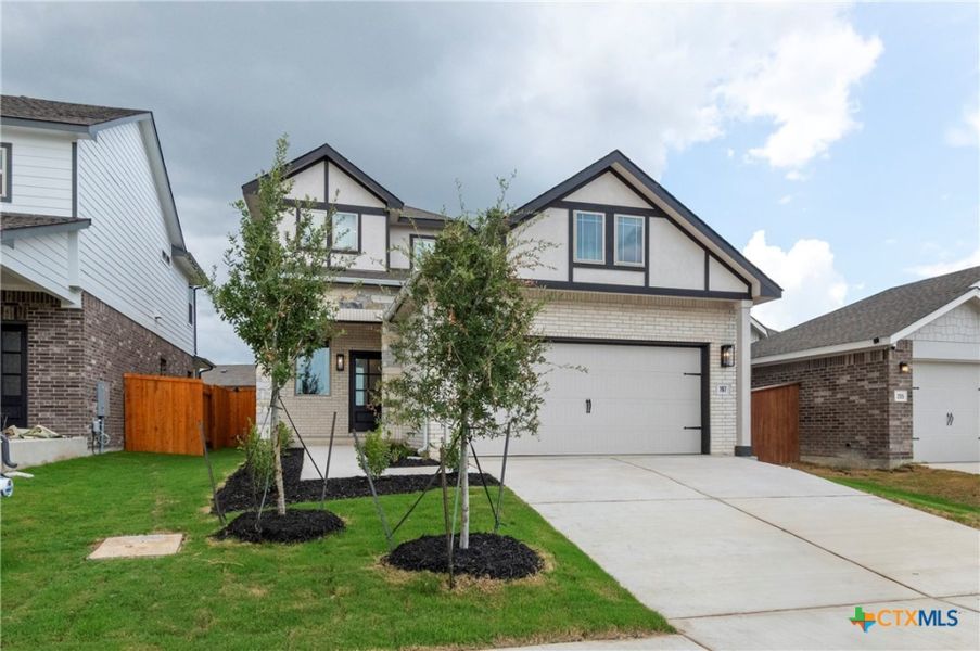 Front exterior of a new home in Crosswinds, Kyle, TX, highlighting curb appeal (Image 23).