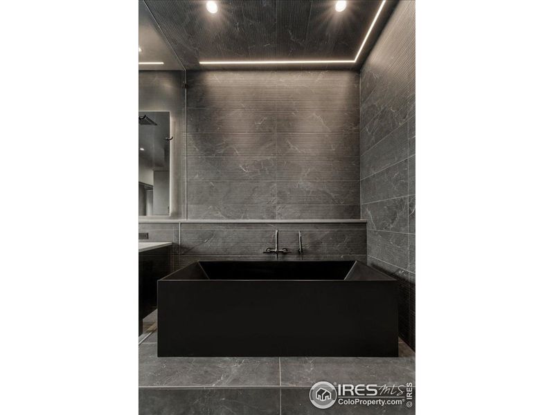 Stone tub plus recessed accent lighting