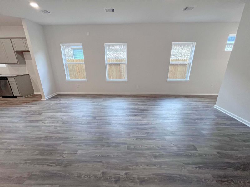 The Mockingbird II- Family Room into the Kitchen. Home under construction. Sample floor plan photo used for illustrative purposes only. Upgrades, selections options, windows and colors may vary.