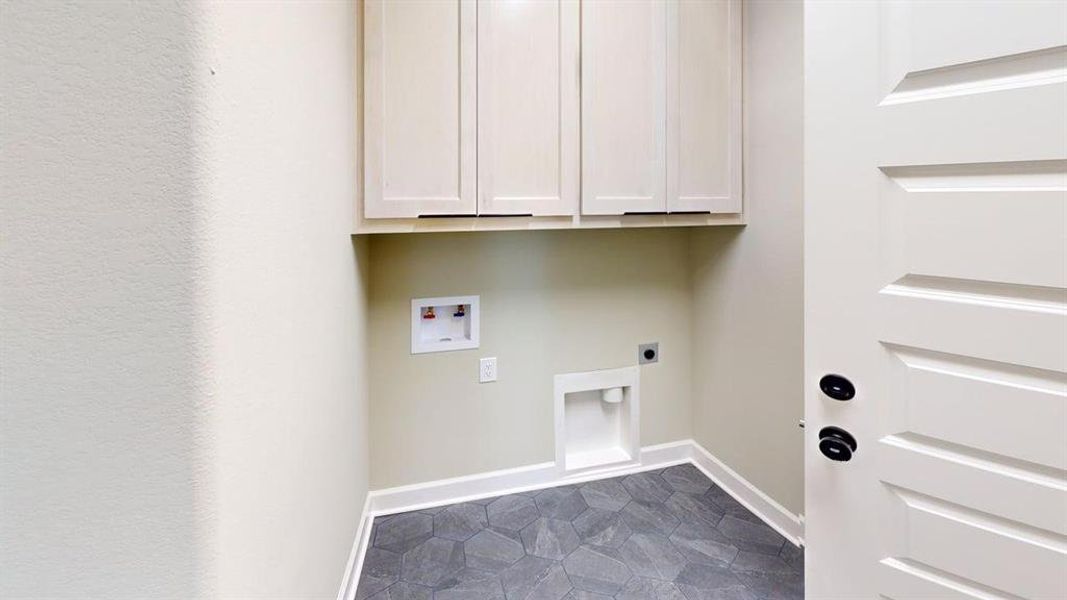 Washroom with hookup for an electric dryer, washer hookup, cabinet space, and baseboards