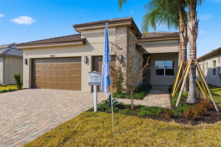 Front exterior of a new home in Valencia Ridge, Wesley Chapel, FL, highlighting curb appeal (Image 2).