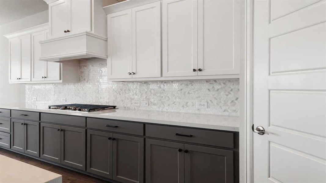 Kitchen featuring gray cabinetry, white cabinetry, dark hardwood / wood-style floors, and stainless steel gas stovetop