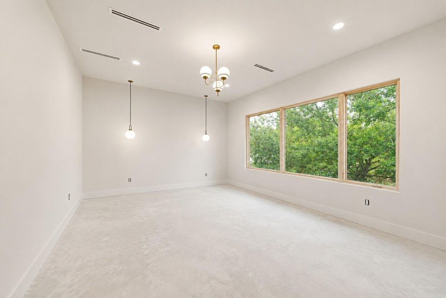 photo of unfinished Primary bedroom with tons of natural light, modern lighting features, flush baseboard detail and sleek ventilation slots.