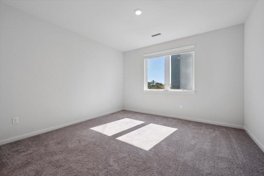 A room with a rug and a window. A room with a rug and a window.