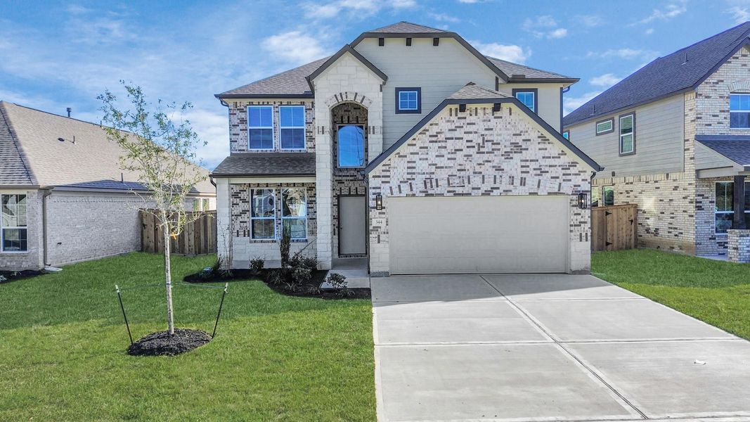 Behold a lush landscape, impeccably maintained yard, and apremium elevation adorned with captivating brick and stone features. Behold a lush landscape, impeccably maintained yard, and apremium elevation adorned with captivating brick and stone features.