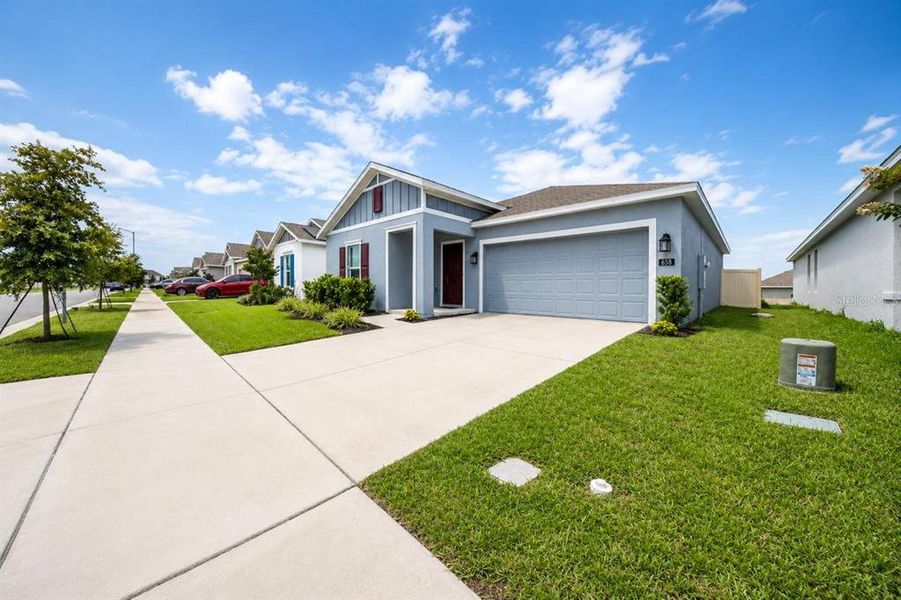 Front exterior of a new home in Lawson Dunes, Haines City, FL, highlighting curb appeal (Image 15). Front exterior of a new home in Lawson Dunes, Haines City, FL, highlighting curb appeal (Image 15).