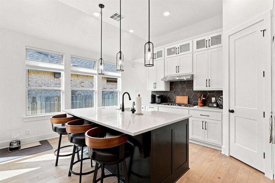 High ceilings and clean lines define this modern kitchen with a large central island.