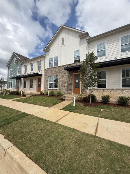 Contemporary townhome exterior featuring light brick and horizontal siding Contemporary townhome exterior featuring light brick and horizontal siding