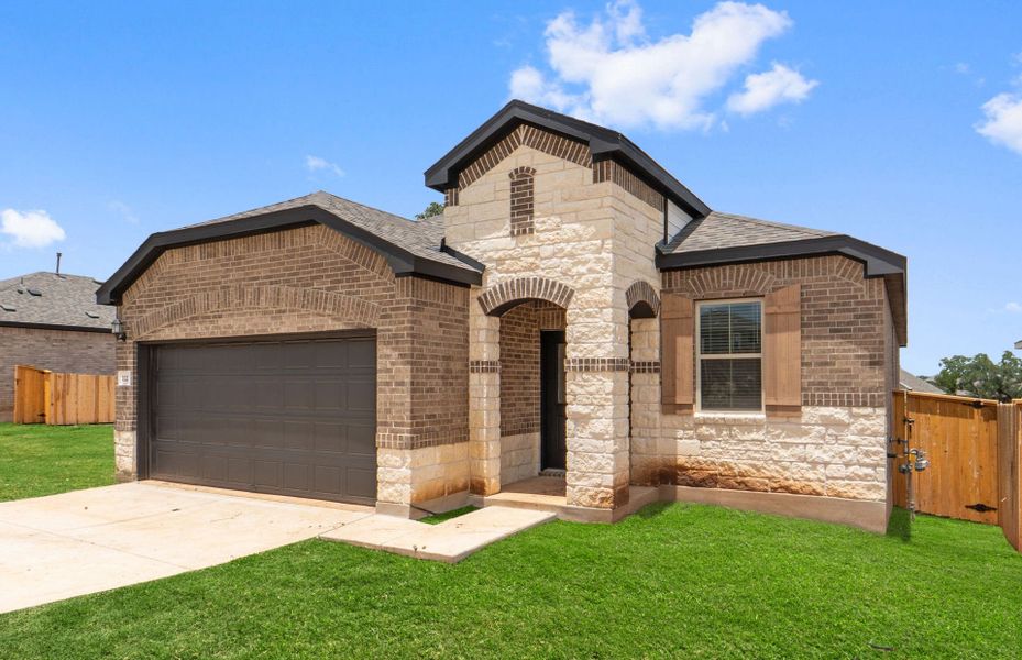 Front exterior of a new home in La Cima, San Marcos, TX, highlighting curb appeal (Image 18).