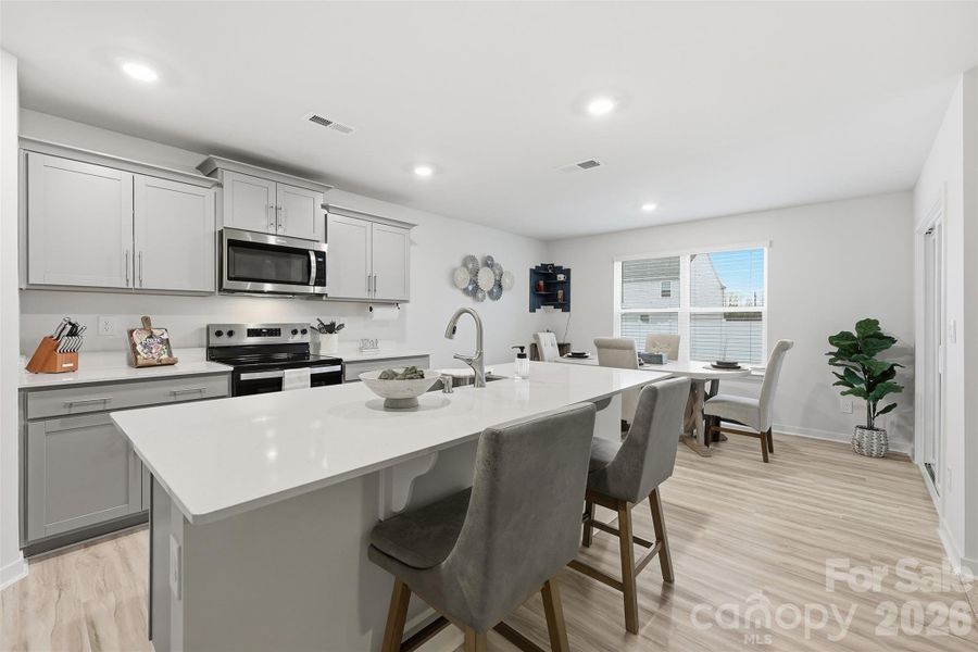 kitchen quartz counter tops, walk-in pantry with wooden shelves