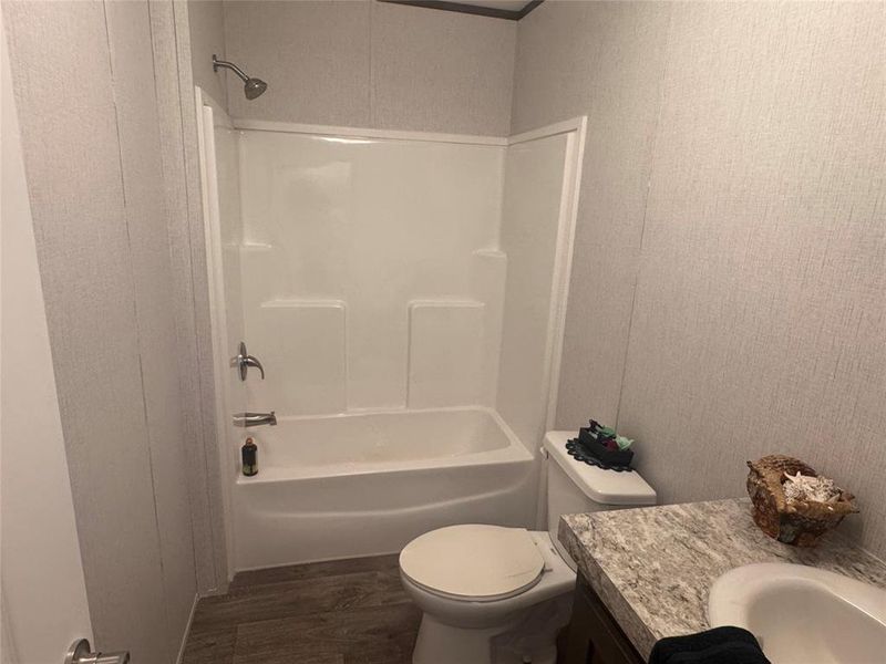 Full bath with vanity, dark wood-type flooring, and tub / shower combination Full bath with vanity, dark wood-type flooring, and tub / shower combination