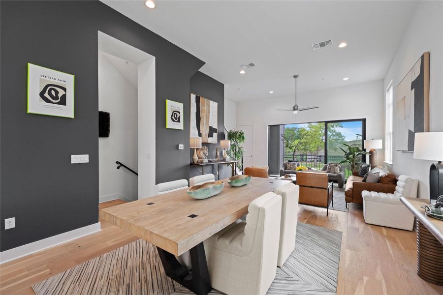 Open-concept living space featuring wood-finish flooring, recessed lighting, a modern ceiling fan, and a floor-to-ceiling sliding glass door