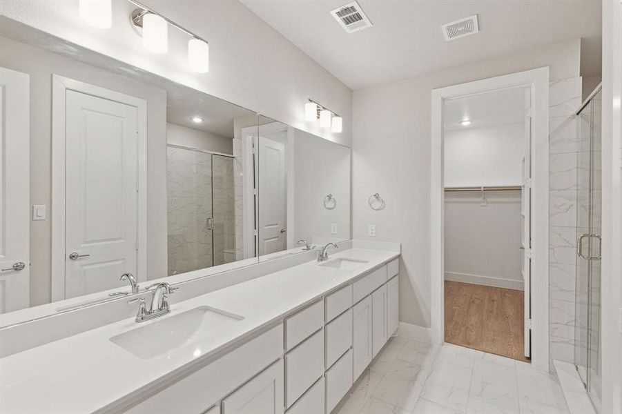 Bathroom with vanity and a shower with shower door