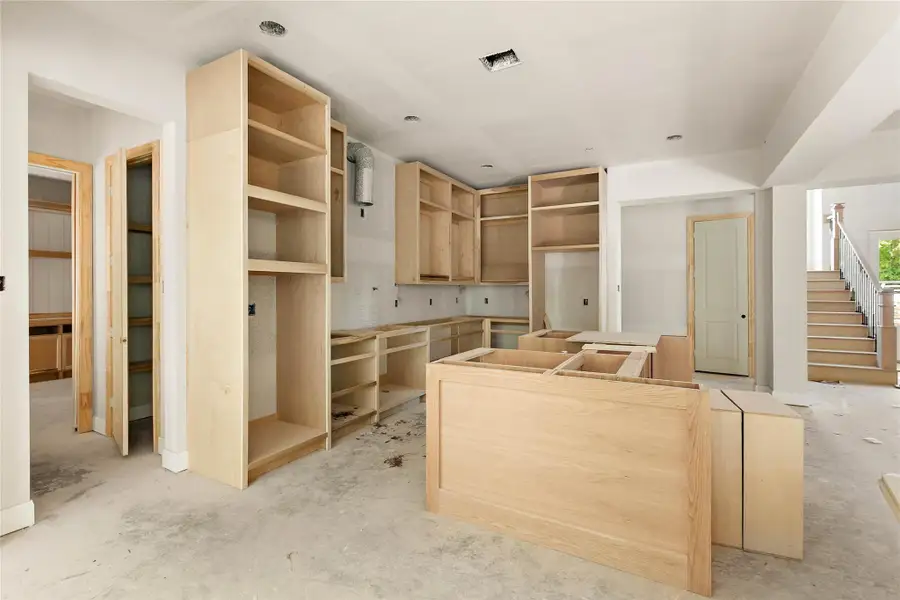 State-of-the-art kitchen with a large center island and custom cabinetry. Perfect for culinary enthusiasts and entertaining guests. State-of-the-art kitchen with a large center island and custom cabinetry. Perfect for culinary enthusiasts and entertaining guests.