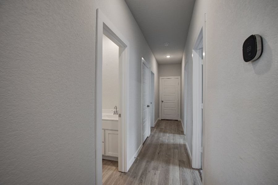 A hallway with white doors.