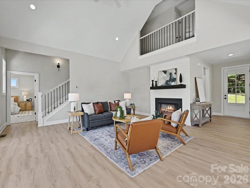 Vaulted ceilings, expansive windows, and an open-concept design fill the stunning great room with natural light while seamlessly connecting the living, dining, and kitchen spaces for effortless entertaining.