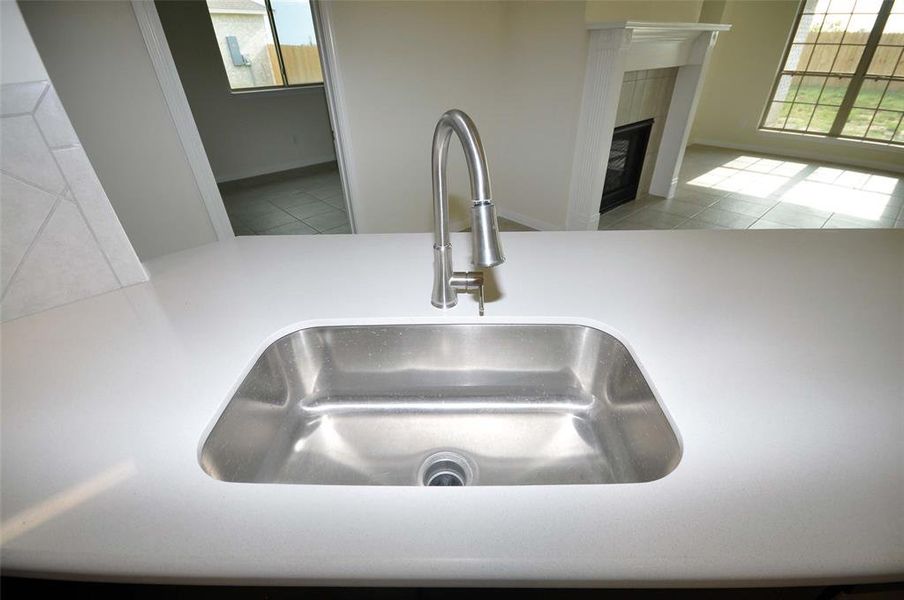 Undercounted Stainless Sink and Omegastone quartz stone counters add to the beauty and functionality.