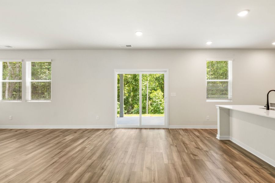A room with a wood floor and windows. A room with a wood floor and windows.
