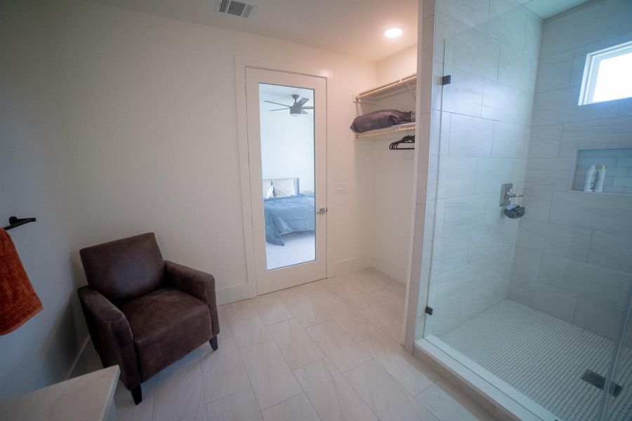 This secondary ensuite is impressively oversized, offering far more than just the essentials. With its expansive layout, there is ample room for a dedicated sitting area, vanity bench, or custom storage furniture, creating a private, boutique-hotel atmosphere right within the suite