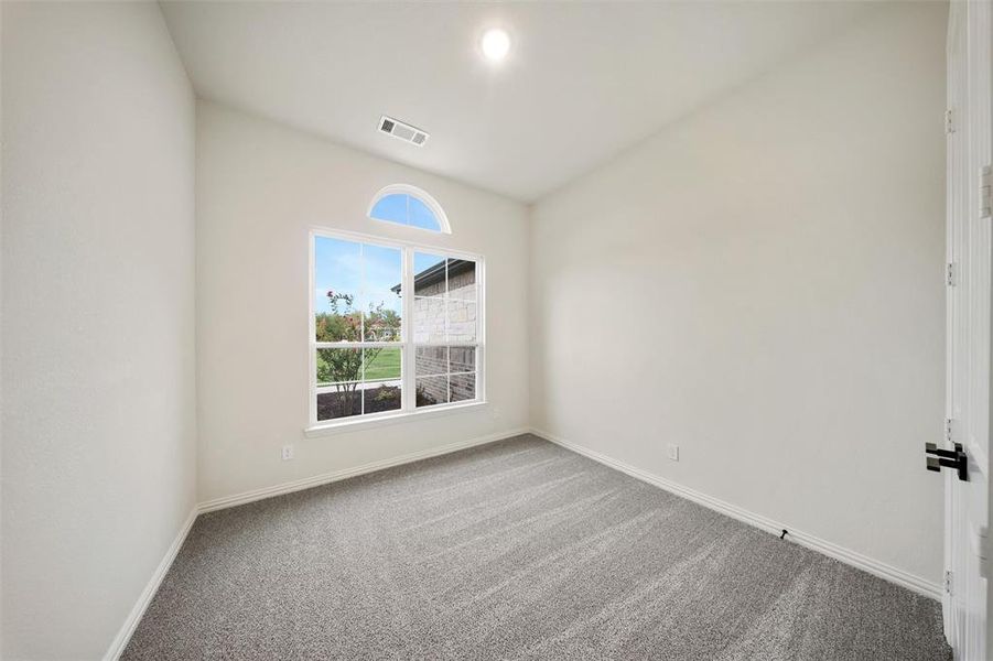 Carpeted empty room featuring baseboards