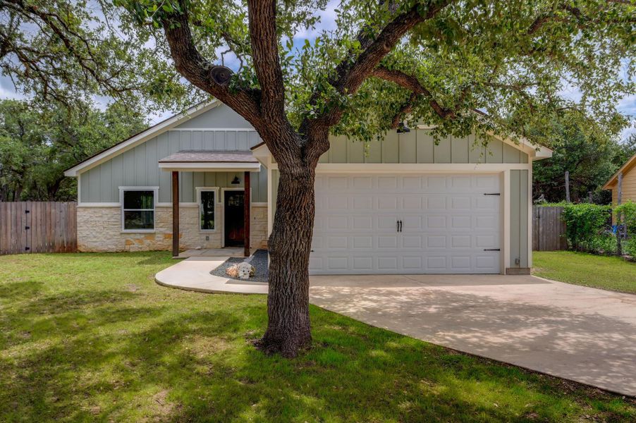 A welcoming facade showcases a single-level home with a two-car garage and mature tree for shade. A welcoming facade showcases a single-level home with a two-car garage and mature tree for shade.