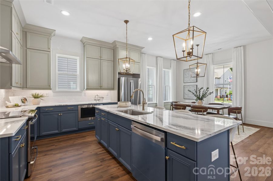 Gracious kitchen invites entertaining and shares an open space for dining and living. Gracious kitchen invites entertaining and shares an open space for dining and living.