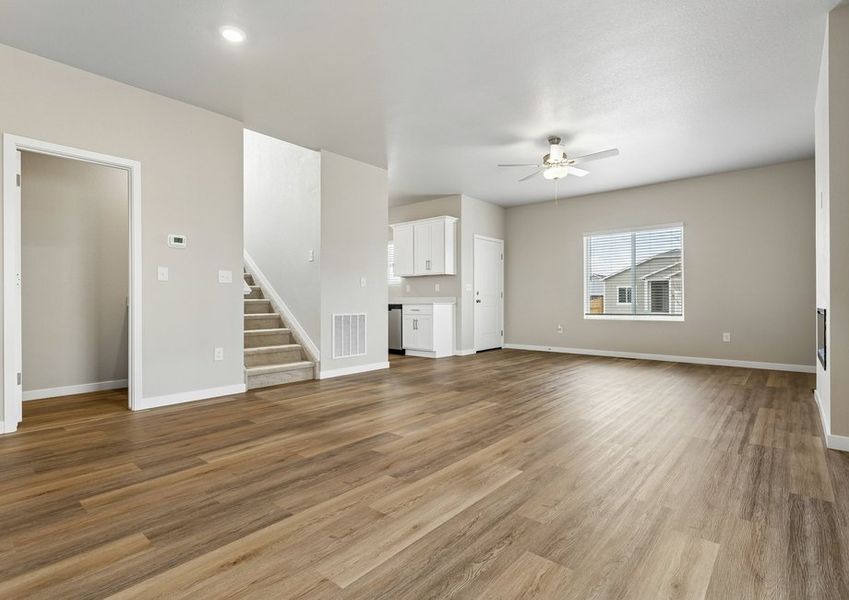 The family room is spacious with a ceiling fan and electric fireplace.