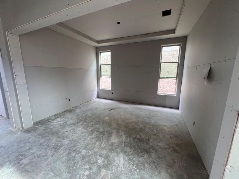 Unfurnished room featuring a raised ceiling