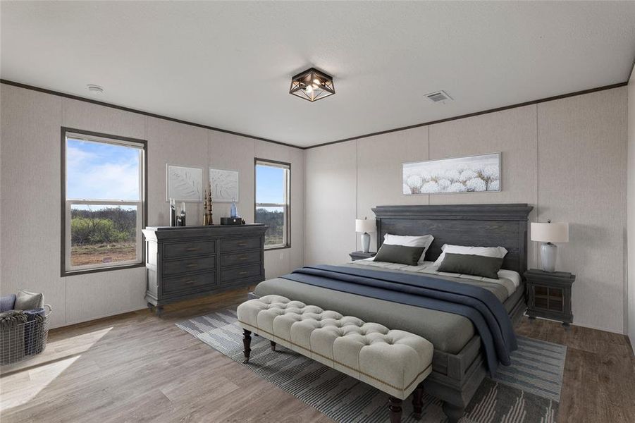 Bedroom with crown molding and wood finished floors