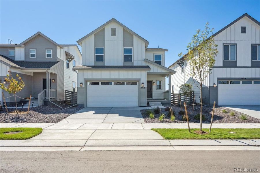 Front exterior of a new home in Legato, Commerce City, CO, highlighting curb appeal (Image 1).