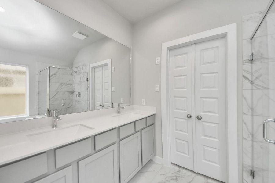 Elevate your daily routine at the elegant vanity, now equipped with double sinks, light countertops, modern hardware, and beautiful recessed lights. Sample photo of completed home with similar floor plan. Actual colors and selections may vary. Elevate your daily routine at the elegant vanity, now equipped with double sinks, light countertops, modern hardware, and beautiful recessed lights. Sample photo of completed home with similar floor plan. Actual colors and selections may vary.