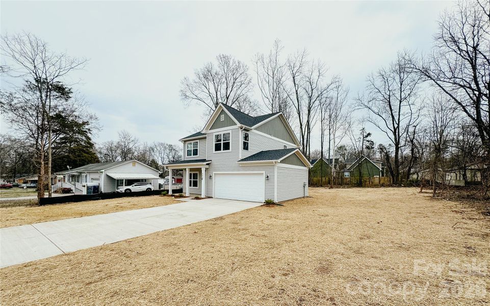 Front exterior of a new home in , Harrisburg, NC, highlighting curb appeal (Image 18).