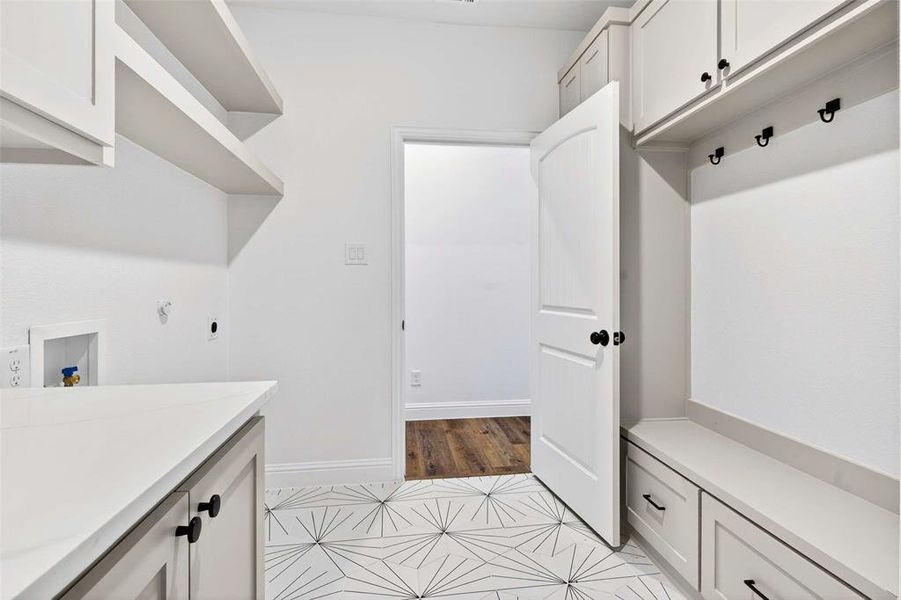 Laundry room featuring light tile patterned floors and hookup for a washing machine