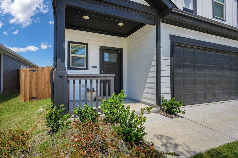 Contemporary exterior featuring white horizontal siding and black trim accents Contemporary exterior featuring white horizontal siding and black trim accents