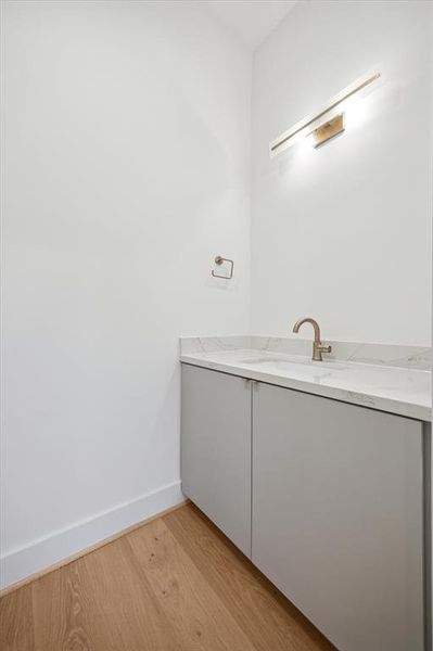 Powder room with Calacutta quartz countertop matching kitchen island.