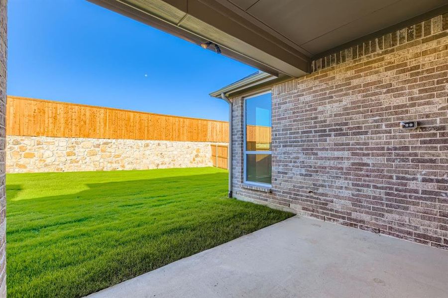 Fenced backyard featuring a patio