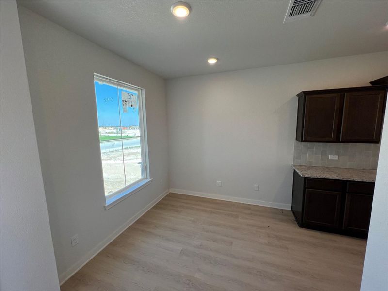 Unfurnished dining area featuring light wood-style floors and recessed lighting