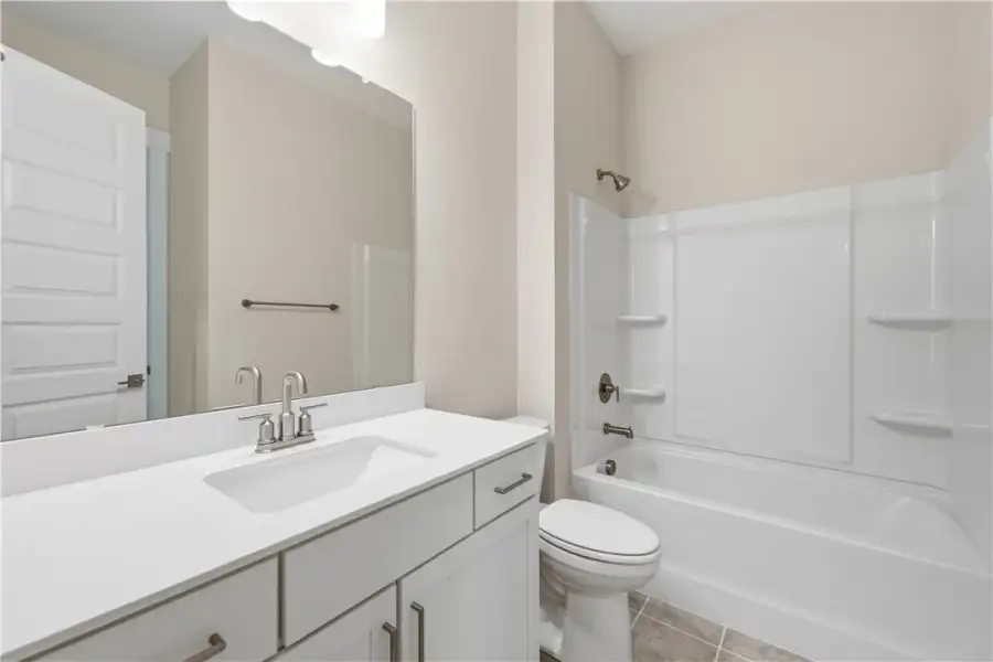 A modern bathroom features a clean white vanity pa