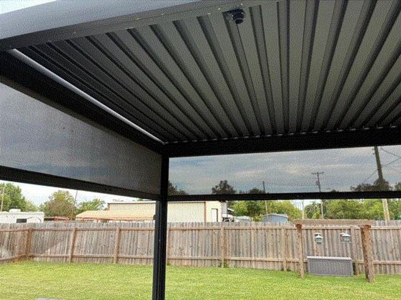 Fenced backyard featuring a pergola