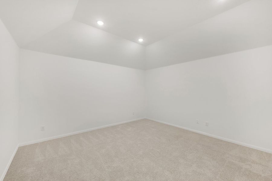 Empty room with white walls, beige carpet, and recessed ceiling lights