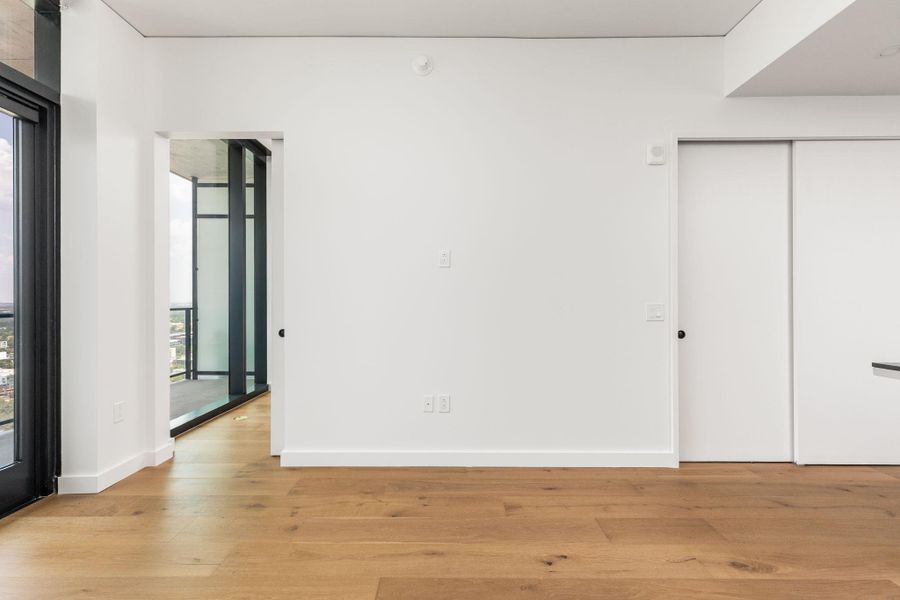 Hardwood flooring spans this open area, offering access to your private balcony.