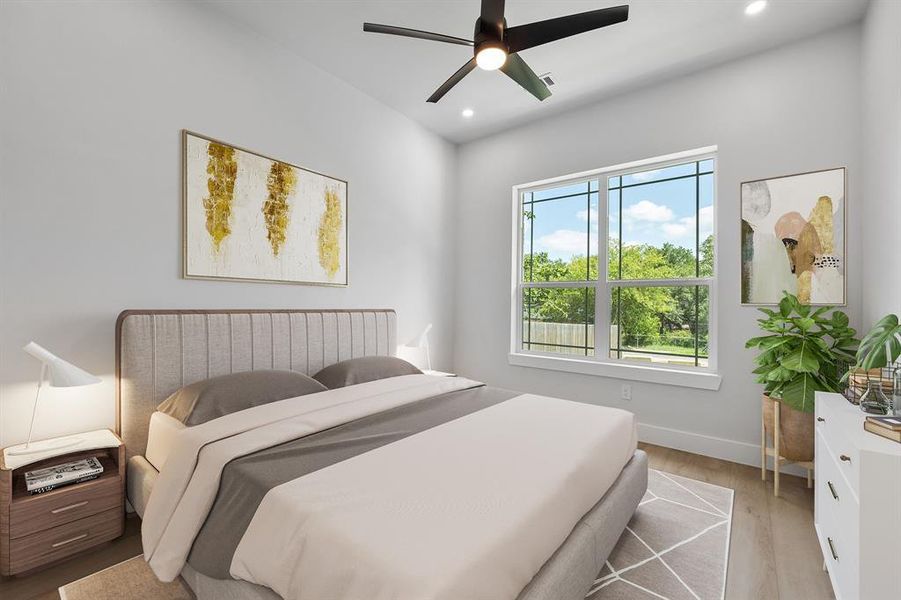 The lower-level ensuite bedroom is near the front door and overlooks the front yard. Virtually staged.