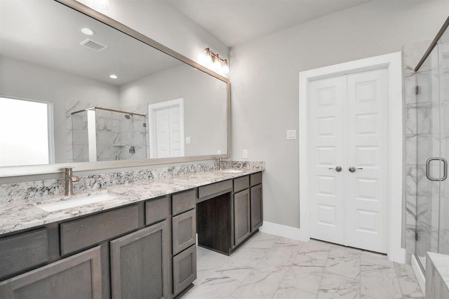 Discover another perspective of the luxurious primary bathroom. Sample photo of completed home with similar floor plan. Actual colors and selections may vary.