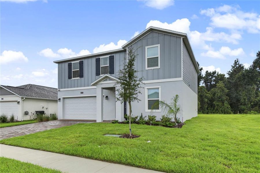 Front exterior of a new home in Providence, Davenport, FL, highlighting curb appeal (Image 2). Front exterior of a new home in Providence, Davenport, FL, highlighting curb appeal (Image 2).