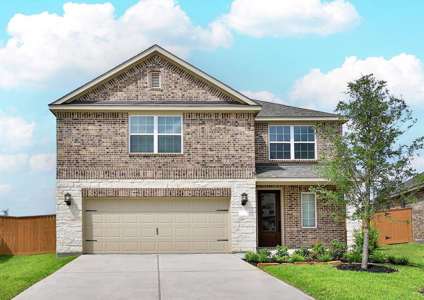 Beautiful brick and stone exterior with front yard landscaping