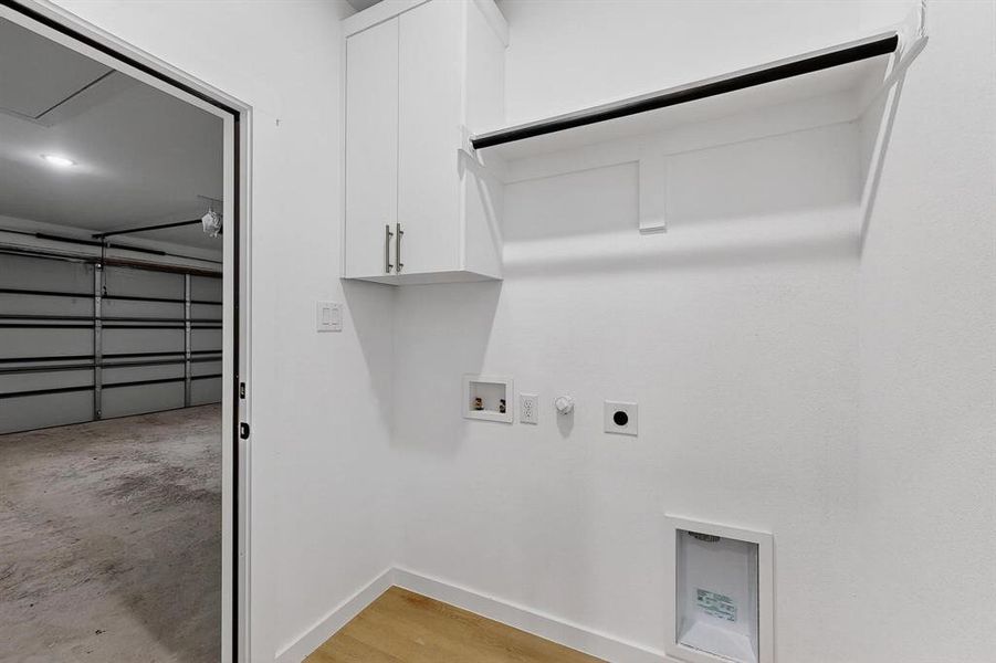 Laundry room with hookup for a gas dryer, hookup for an electric dryer, washer hookup, and concrete floors Laundry room with hookup for a gas dryer, hookup for an electric dryer, washer hookup, and concrete floors