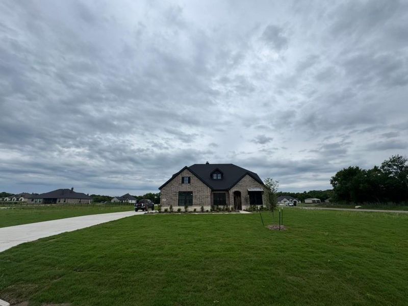 Front exterior of a new home in King Crossing Estates, Van Alstyne, TX, highlighting curb appeal (Image 15).