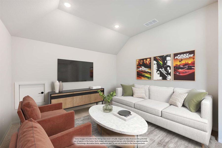 Living room with vaulted ceiling, gray sofa, wall-mounted TV, and movie posters above media console Living room with vaulted ceiling, gray sofa, wall-mounted TV, and movie posters above media console