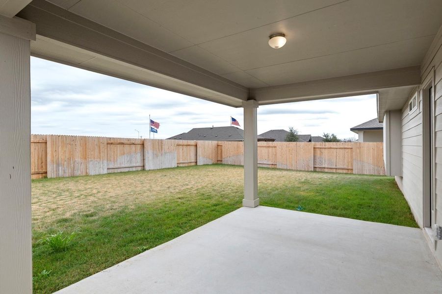 Fenced backyard with a patio area