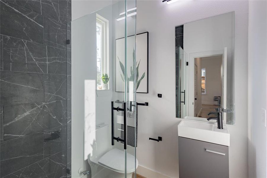 In-law suite Bathroom with vanity and a marble finish shower In-law suite Bathroom with vanity and a marble finish shower